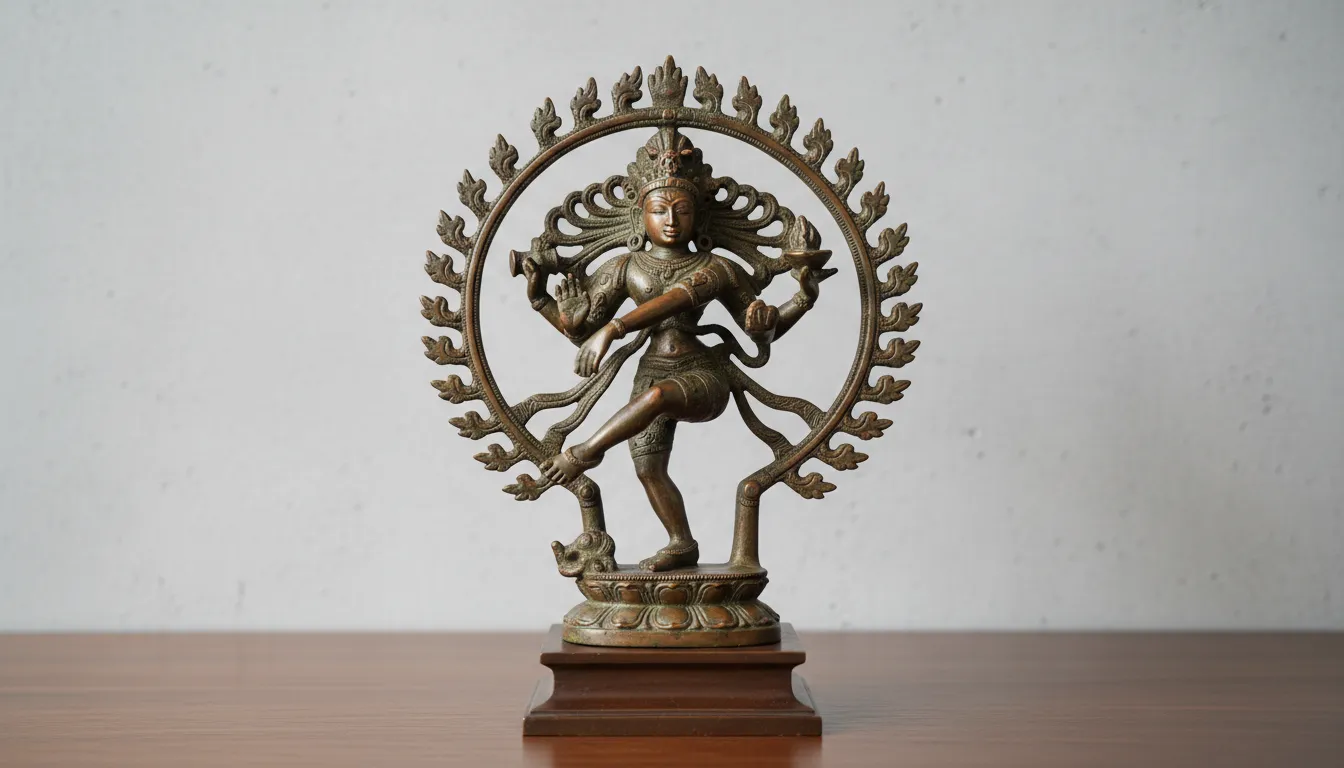Classical bronze Nataraja artifact positioned against a clean minimalist light grey wall