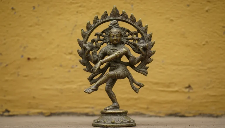Small vintage bronze dancing Shiva figurine placed on a rustic mustard yellow surface