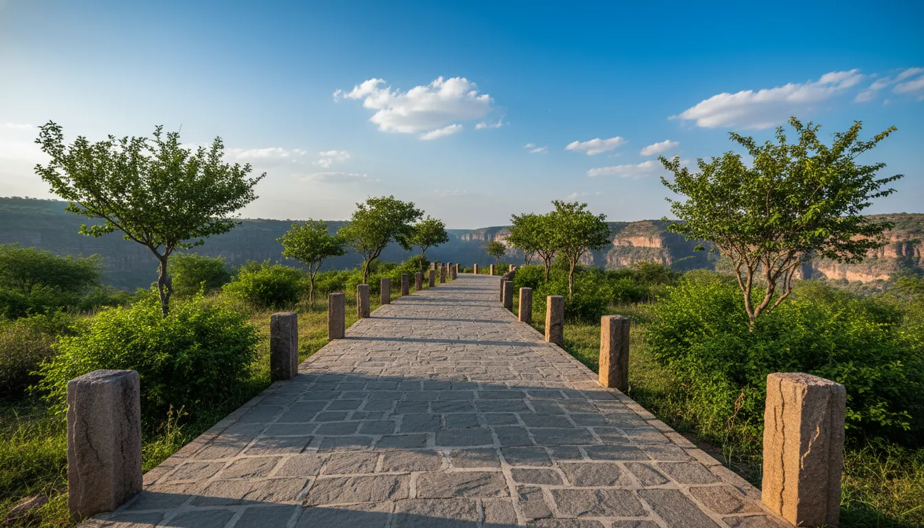 Stone paved pathway leading towards the Garadia Mahadev temple viewpoint surrounded by trees.