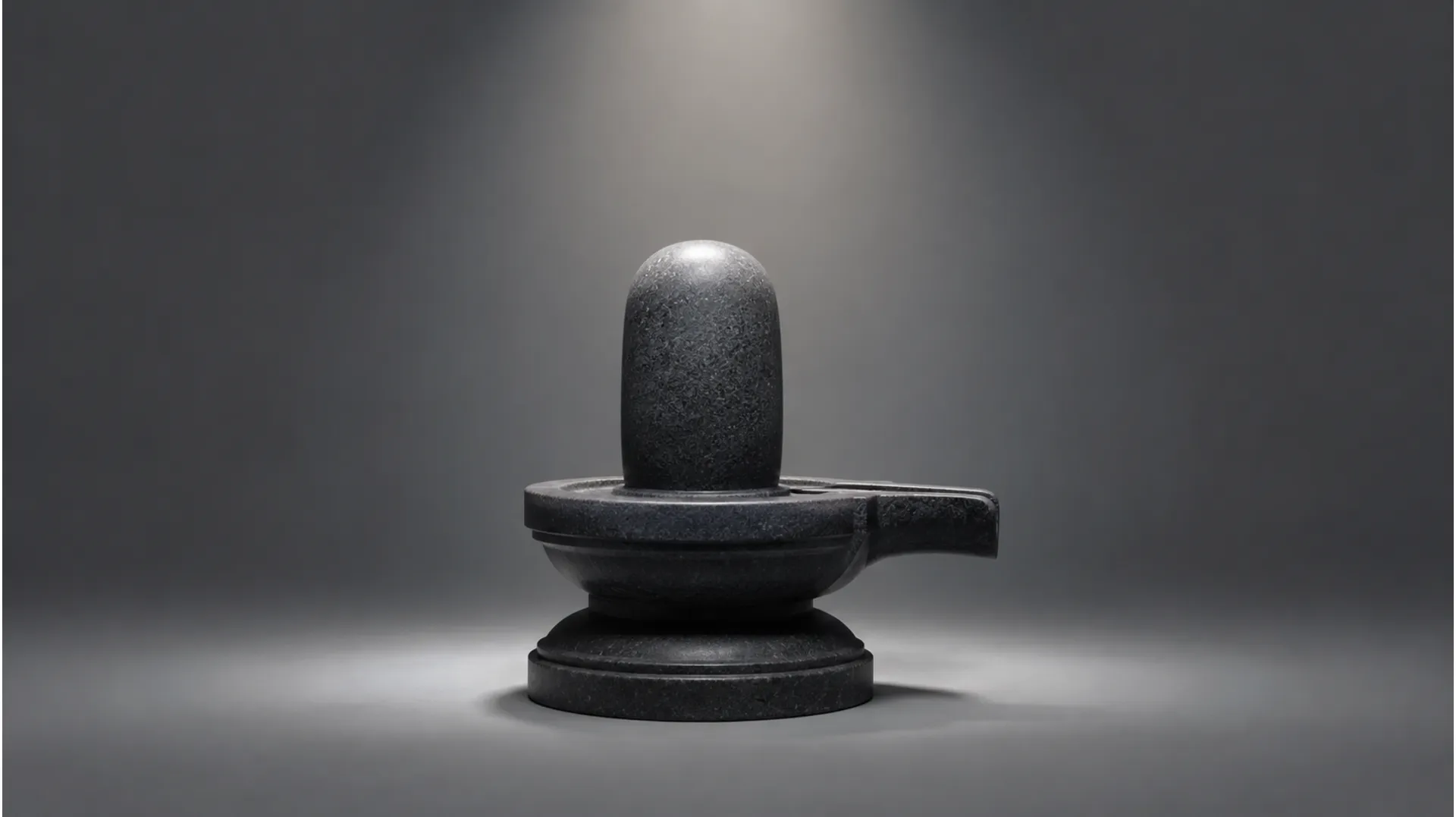 Simple and elegant minimalist design of a dark granite Shiva lingam with subtle lighting.