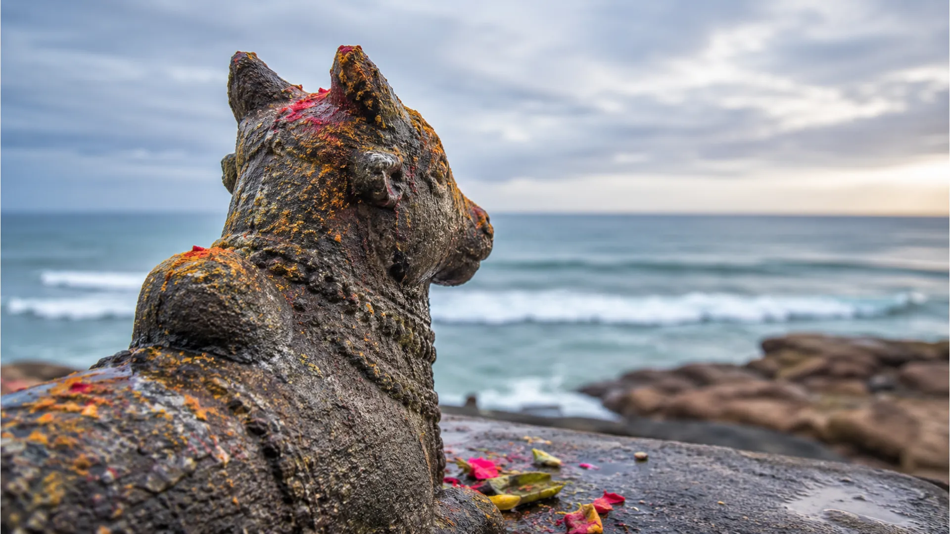 Detailed close-up of a carved stone Nandi idol facing the Shiva Lingas at Nishkalank Mahadev Temple.