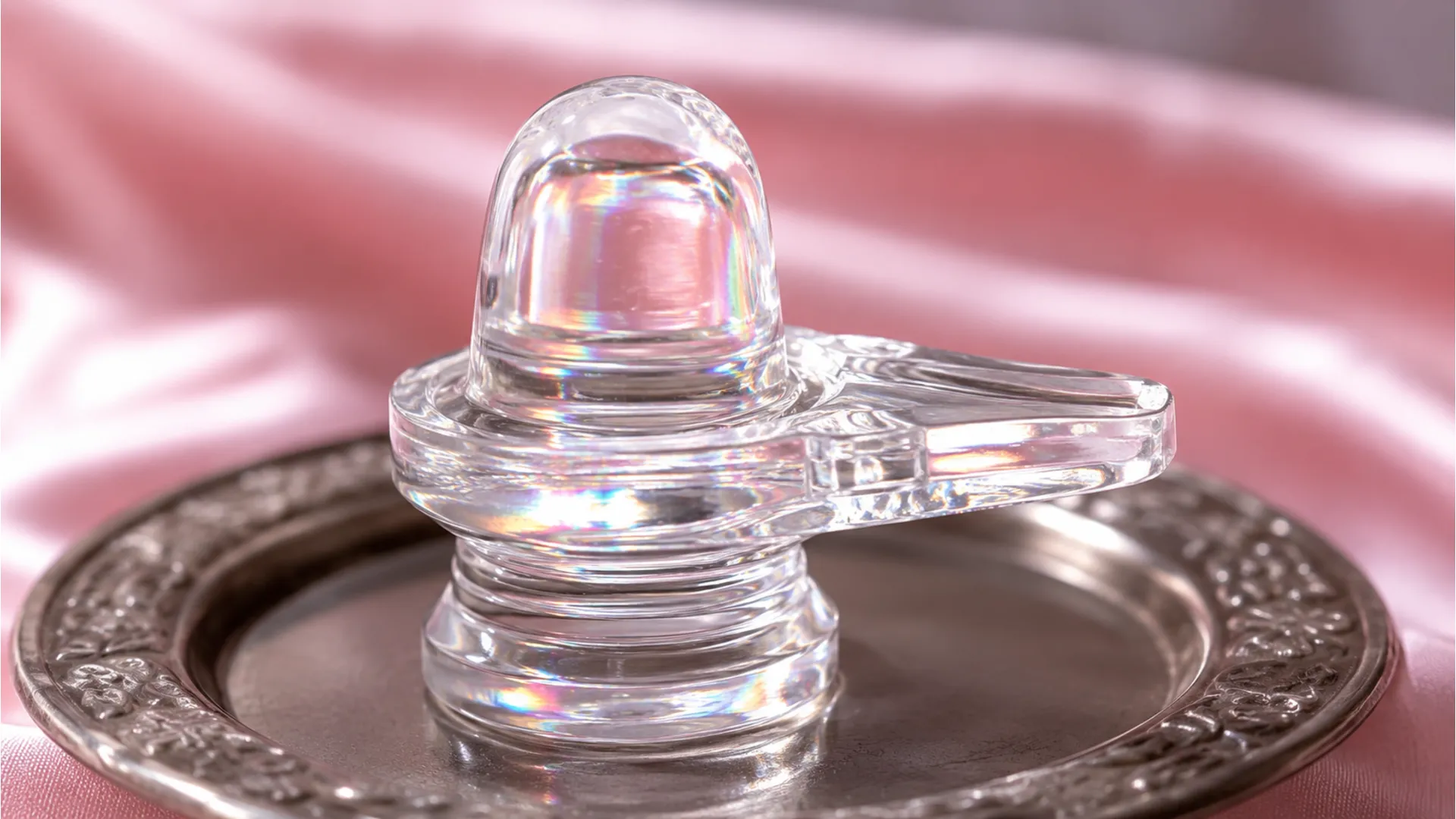 A transparent clear quartz crystal Sphatik Shivling photo image reflecting light.