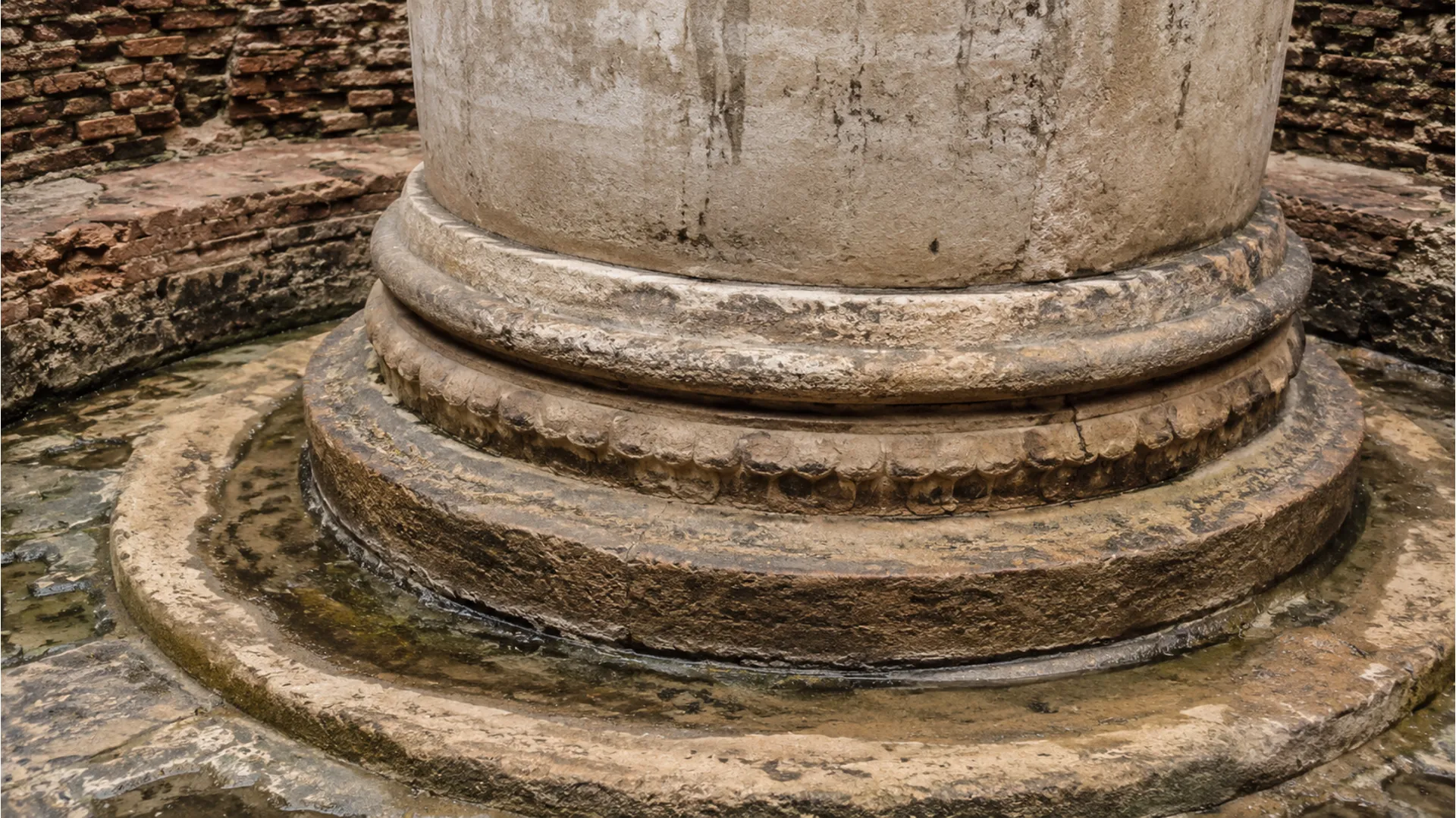 Detailed view of the lower circular base or foundation structure of the Gyanvapi stone.