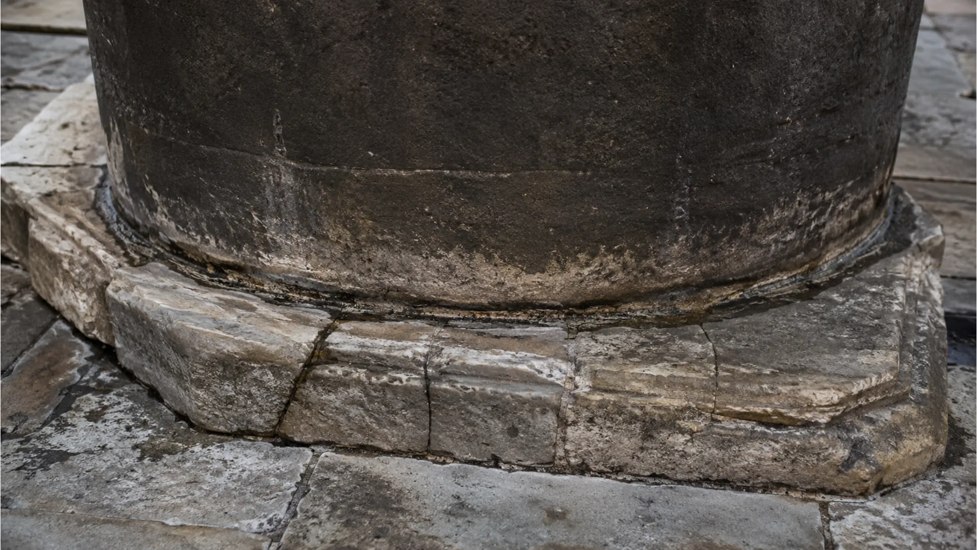 Close-up shot focusing on the foundation stones and masonry work at the bottom of the structure.