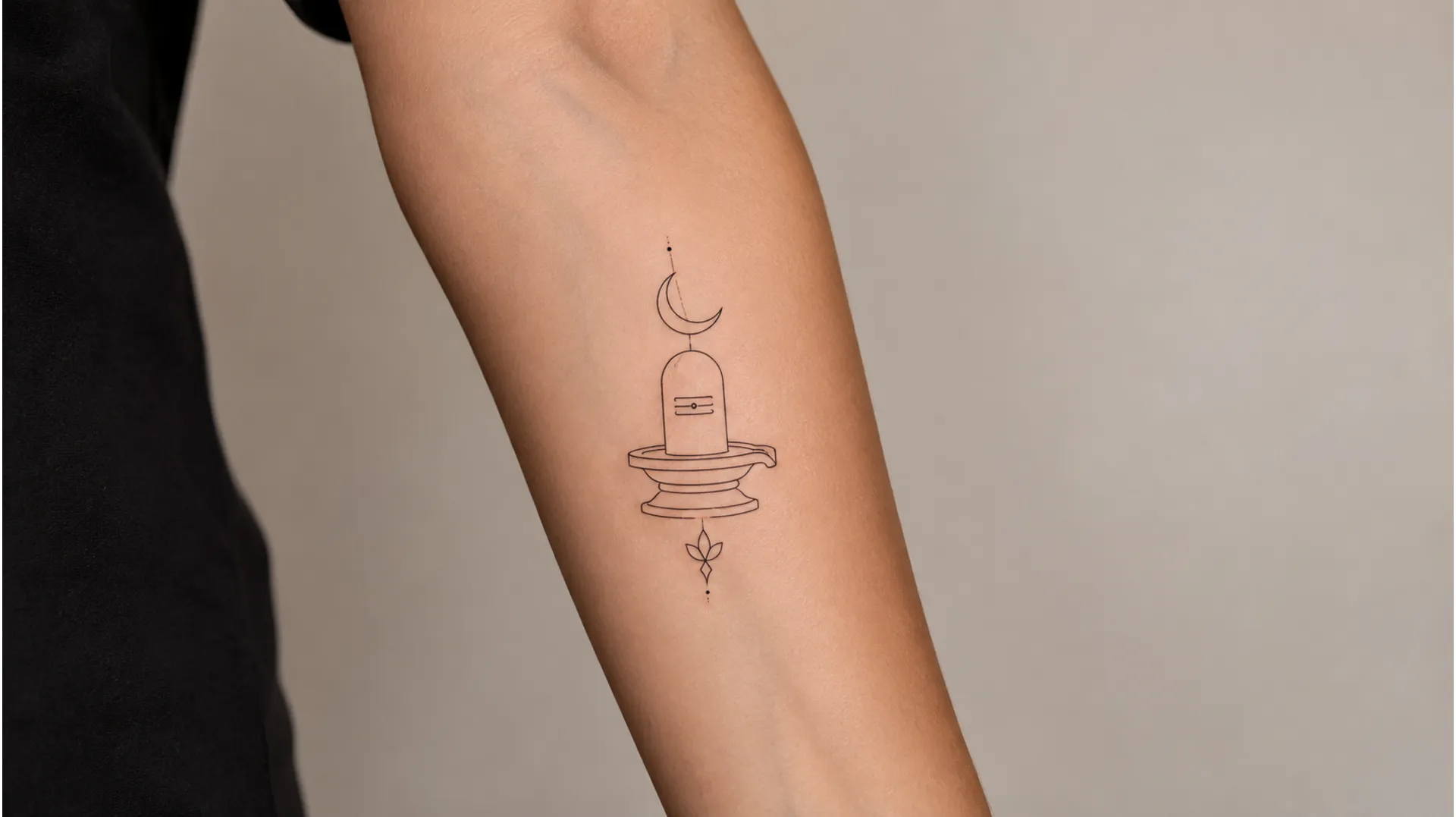 Minimalist fine line shivling tattoo image on the inner forearm featuring clean geometric lines and a subtle crescent moon.