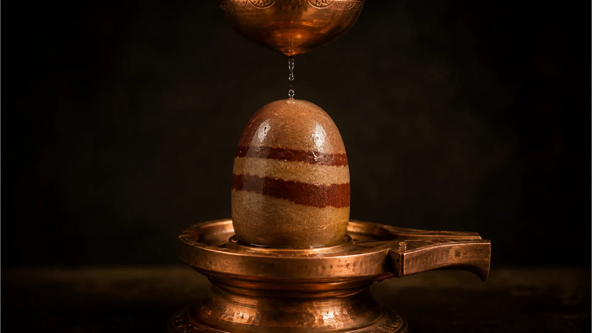 A natural Narmadeshwar Shivling photo image with distinct brown and red patterns.