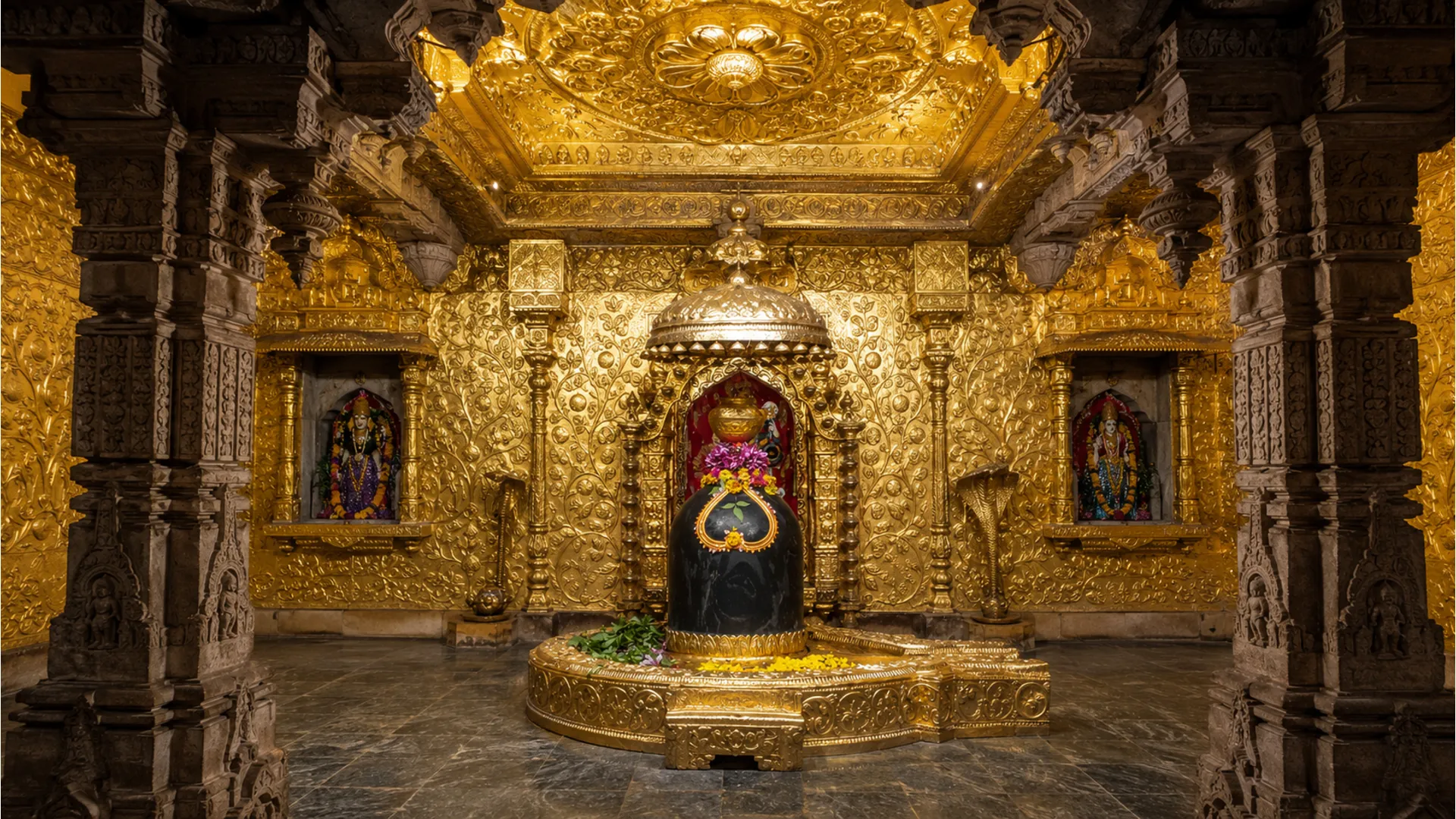 The detailed stone pillars and golden ceiling of the Somnath Temple Garbhagriha with the central Shivling