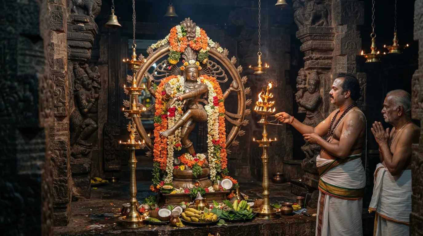 Lord Nataraja idol decorated with fresh morning flowers inside a traditional South Indian temple sanctum.