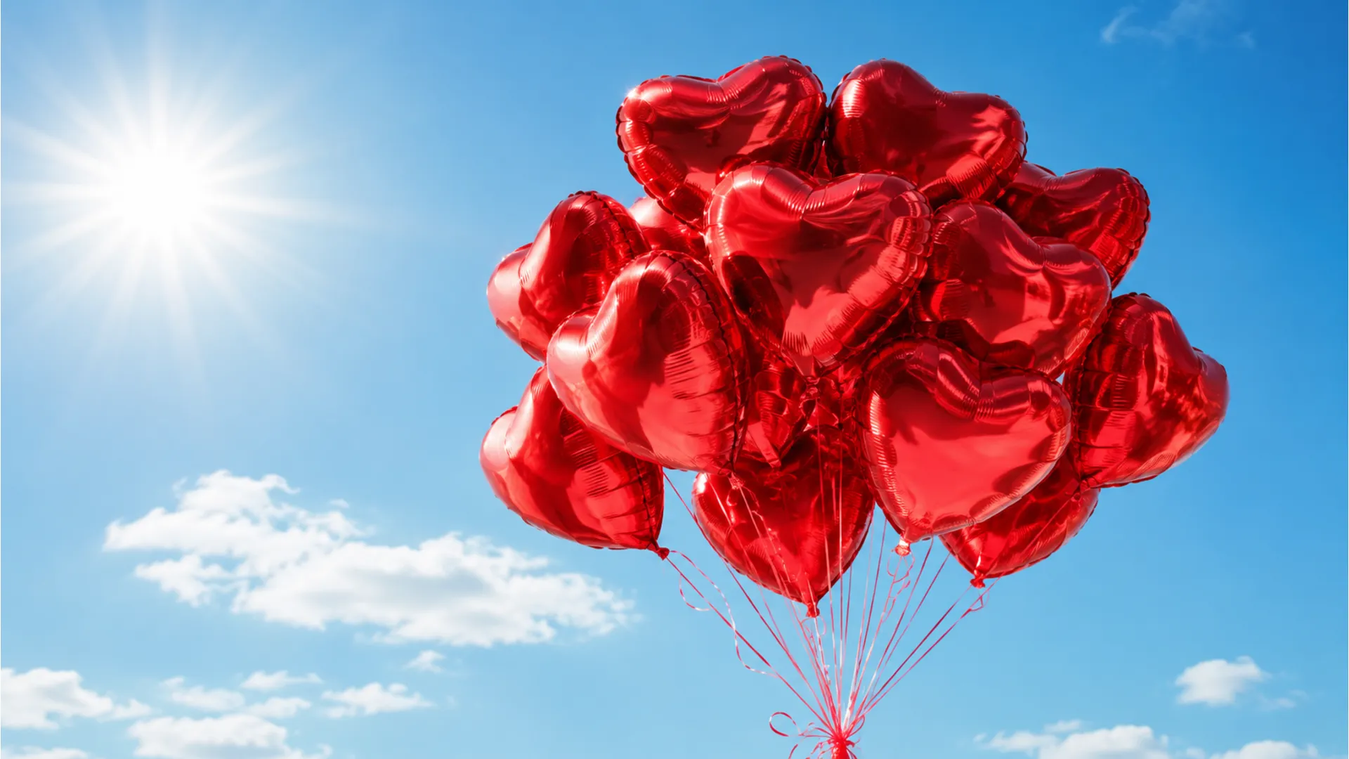 Red heart balloons floating in a clear blue morning sky with romantic text.