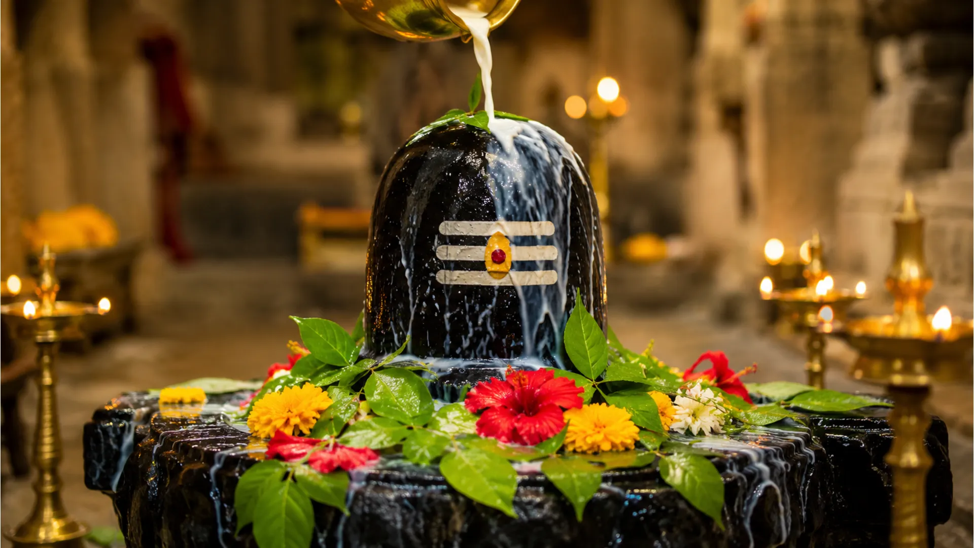 A vibrant, high-definition photo of a traditional dark stone Shivling being offered fresh milk and water during an 'Abhishek' ritual, adorned with flowers and offerings.