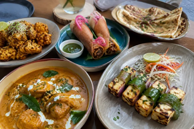 Vegetarian Indian fusion dishes with paneer, tofu and curry on a table